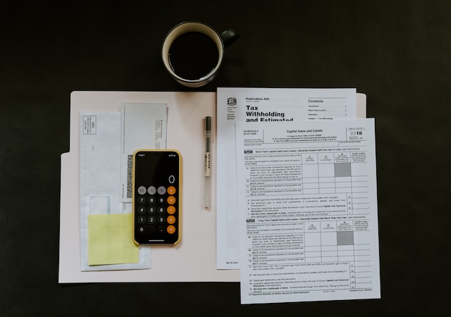 graphic of a irs tax forms with calculator and pen